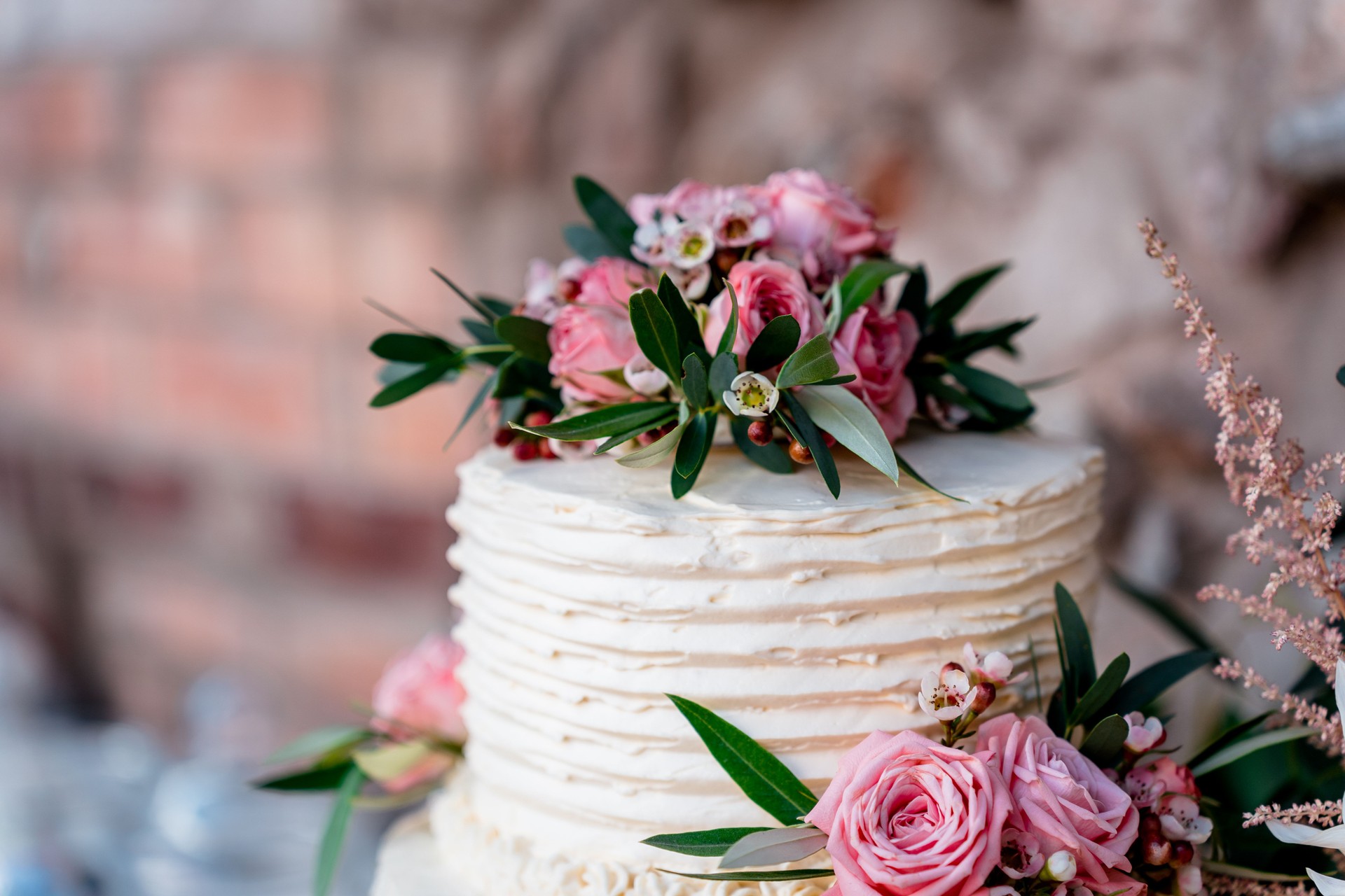 Cream wedding cake with pink roses