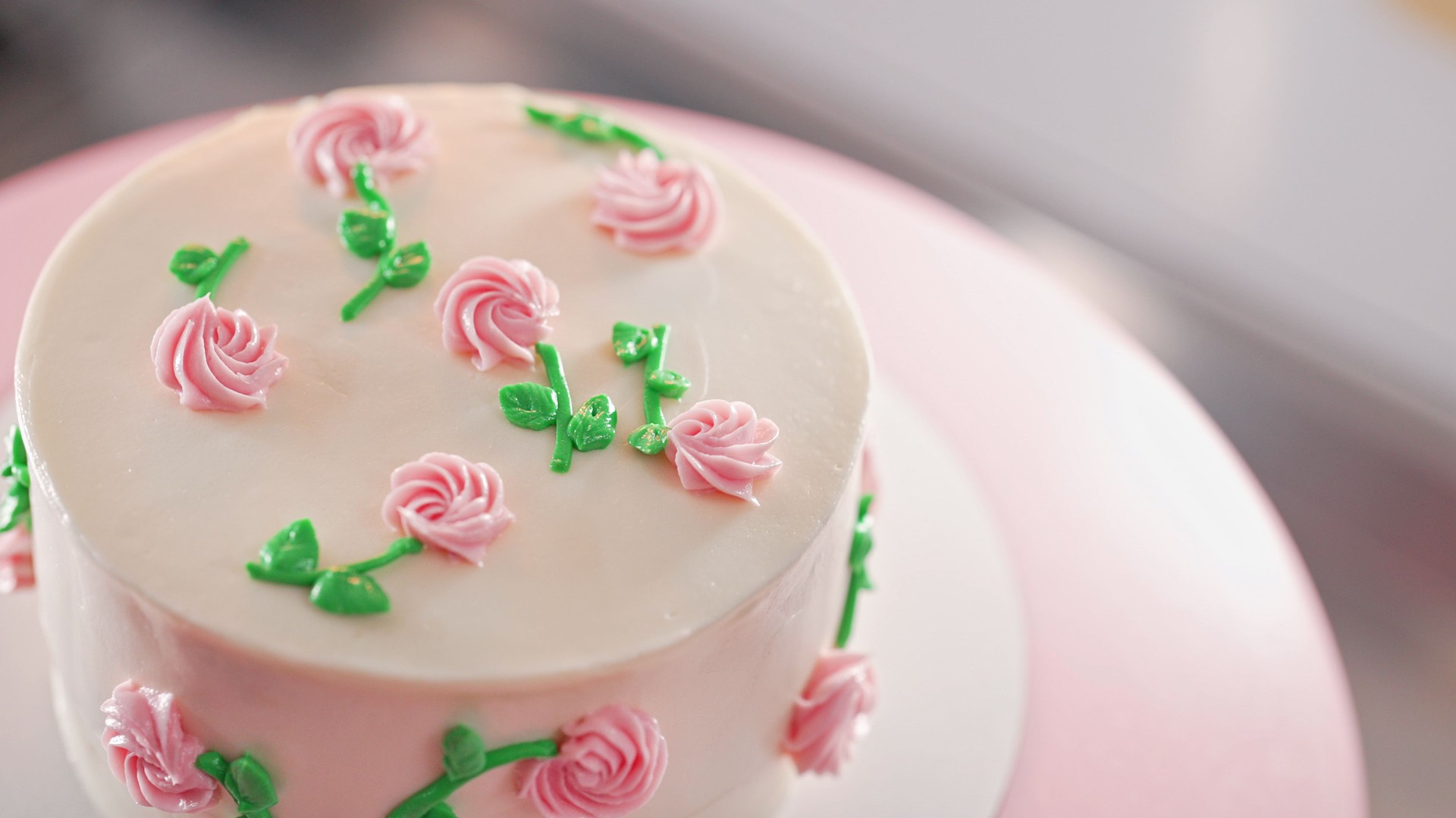 Elegant cake on turntable.Pink buttercream flowers on frosting. Bakery, pastry
