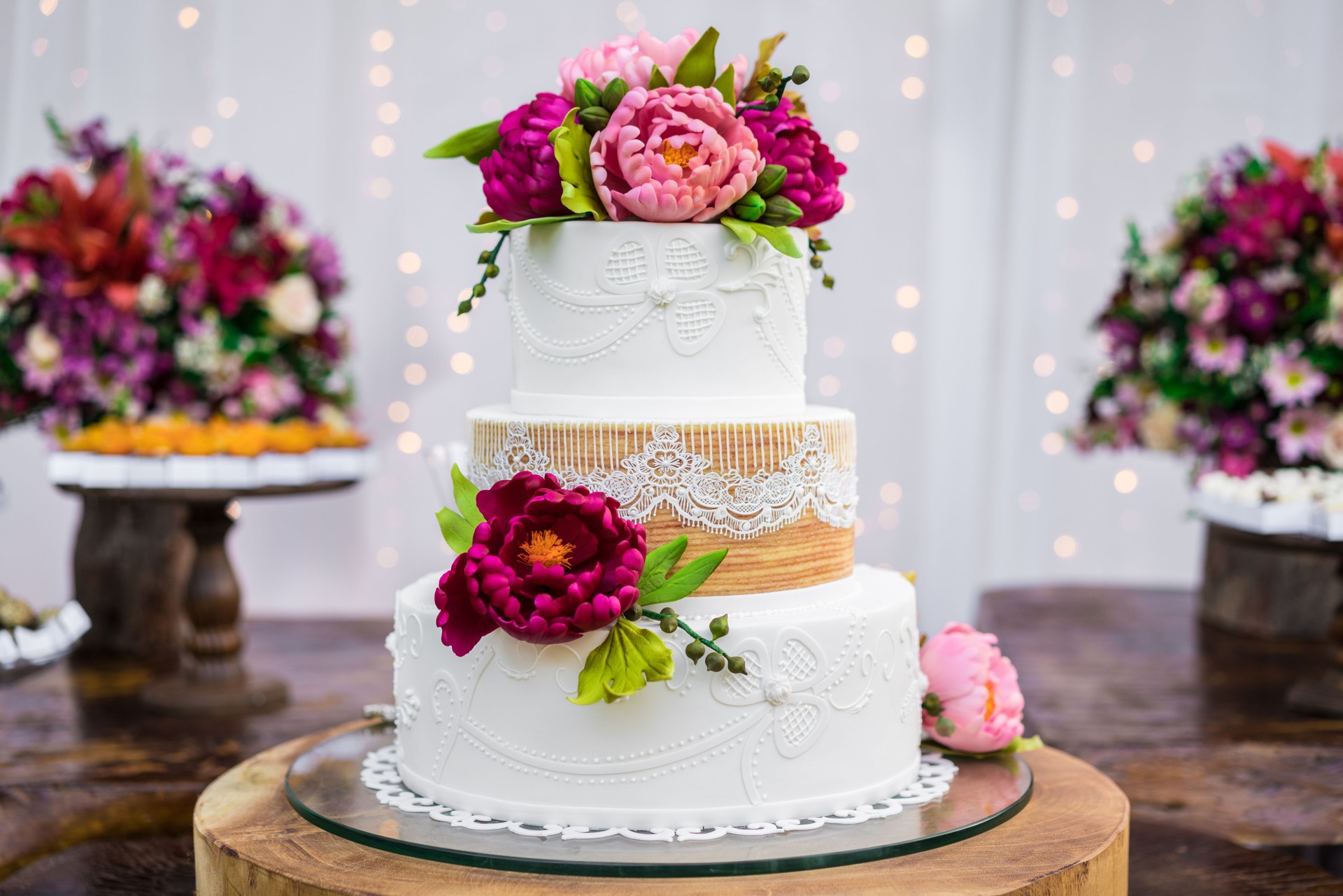 Wedding cake and candies decorating the wooden table