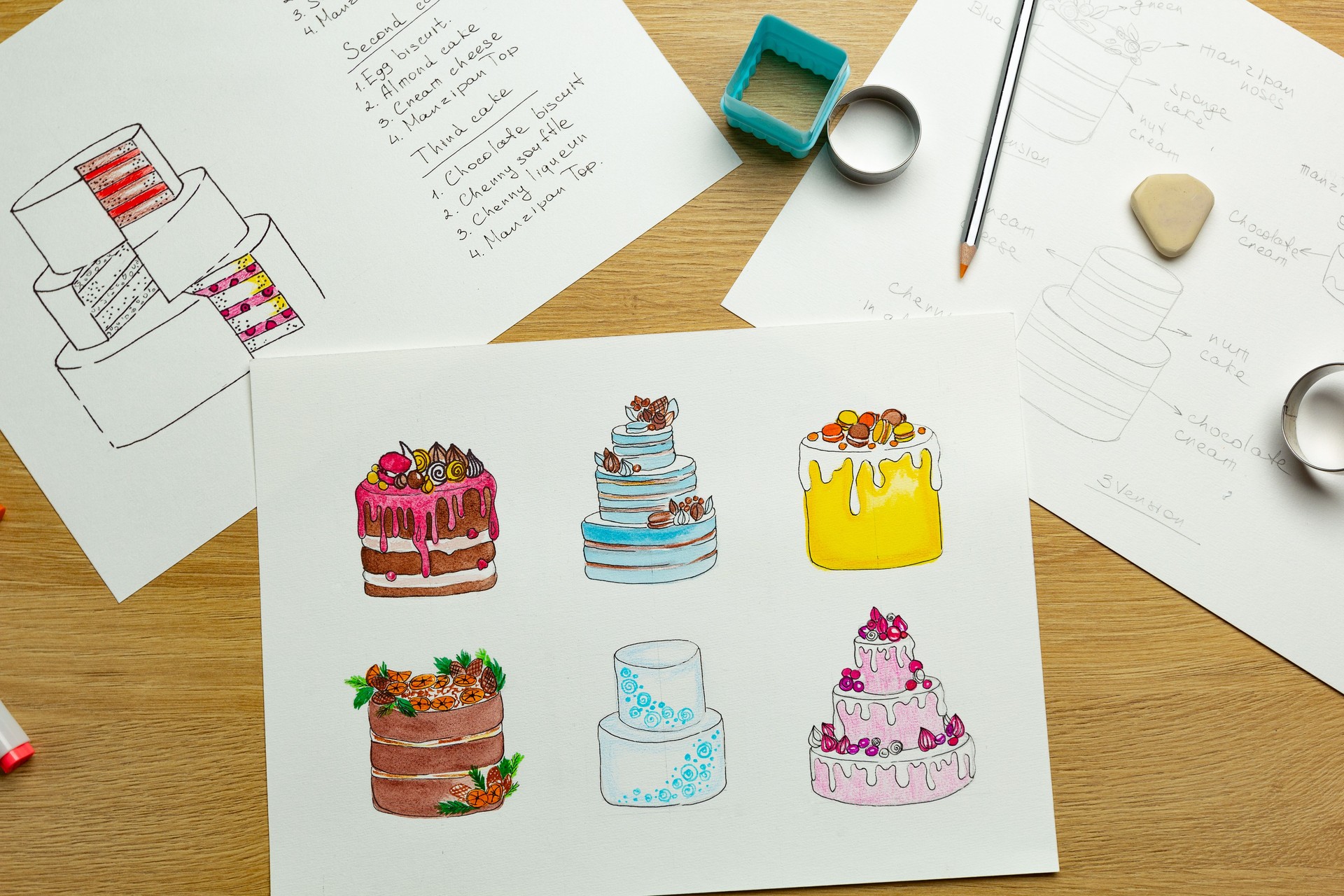 Designer sketches of cakes drawn on paper.