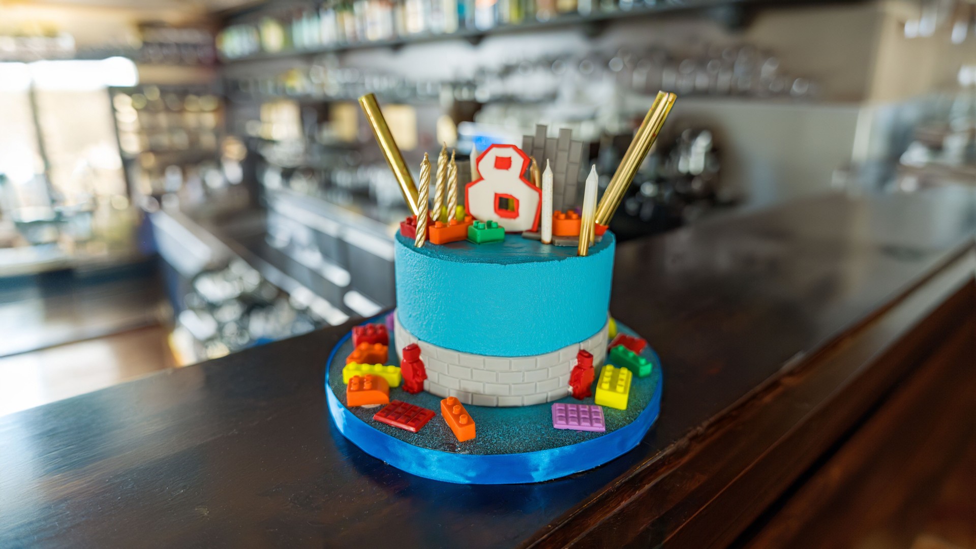 Blue fondant cake with candles and constructor pieces. 8th birthday.