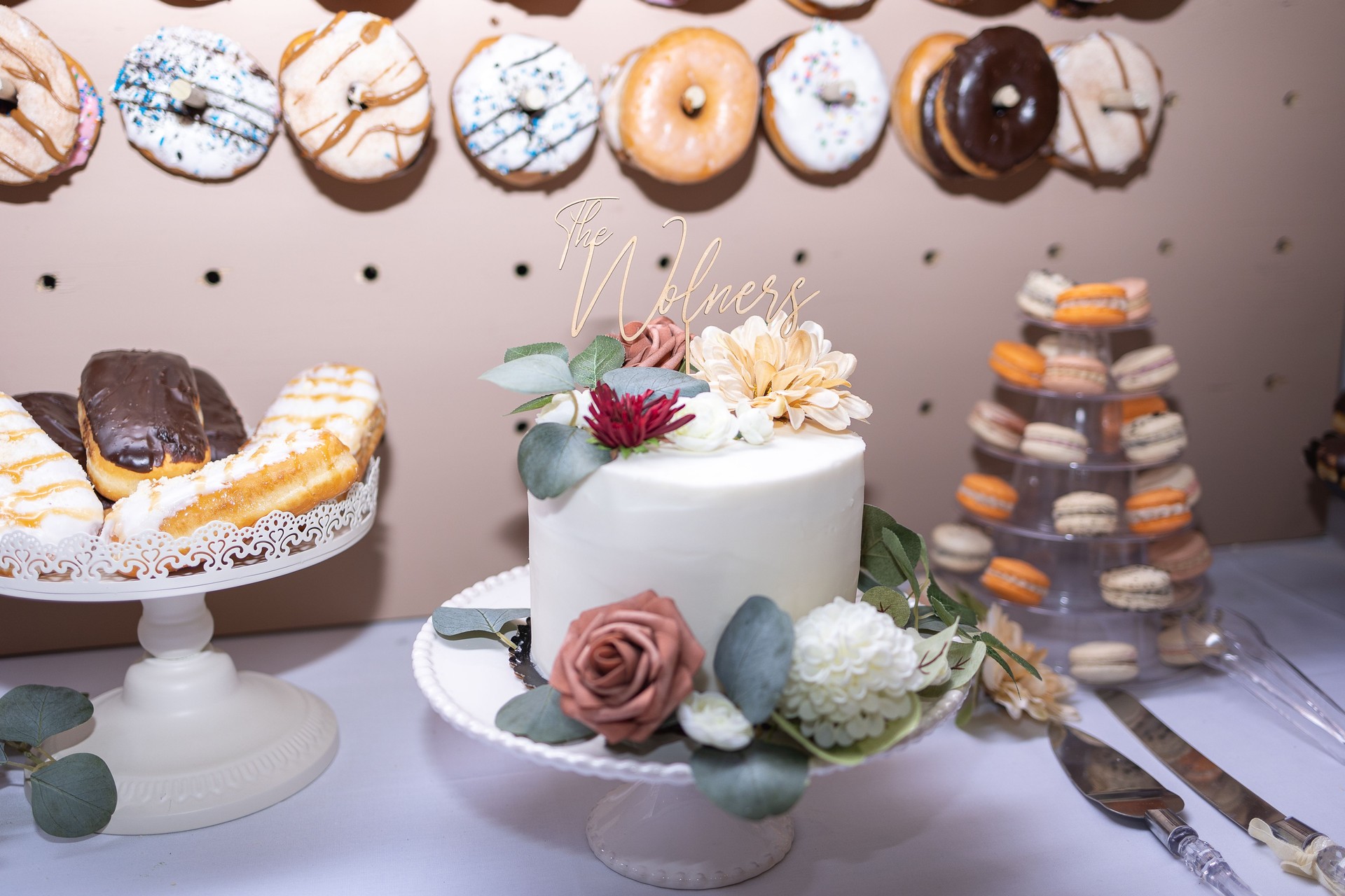 Wedding cake with a donut wall and macarons